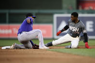 Washington Nationals' Victor Robles, right, steals second as Colorado Rockies shortstop Jose Iglesias tries to make the tag during the fifth inning of the second baseball game of a doubleheader Saturday, May 28, 2022, in Washington. (AP Photo/Nick Wass)