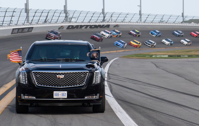 US President Donald Trump and First Lady Melania Trump ride in the Presidential limousine as they take a pace lap ahead of the start of the Daytona 500 Nascar race at Daytona International Speedway in Daytona Beach