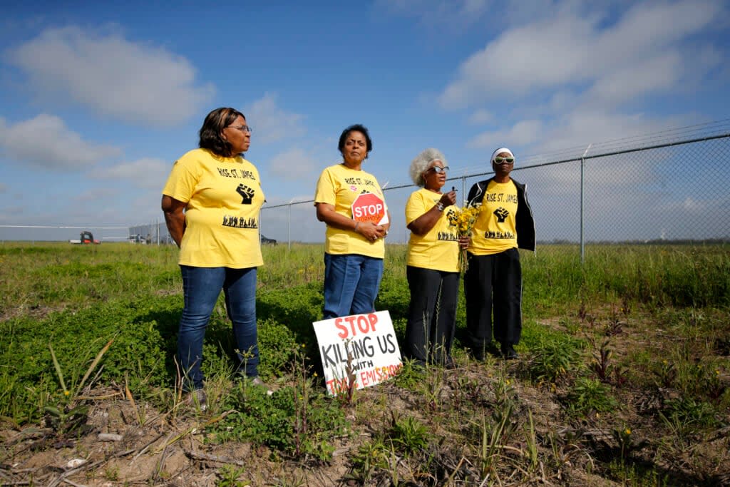 Myrtle Felton, from left, Sharon Lavigne, Gail LeBoeuf and Rita Cooper, members of RISE St. James, conduct a live stream video on property owned by Formosa on March 11, 2020, in St. James Parish, La. (AP Photo/Gerald Herbert, File)