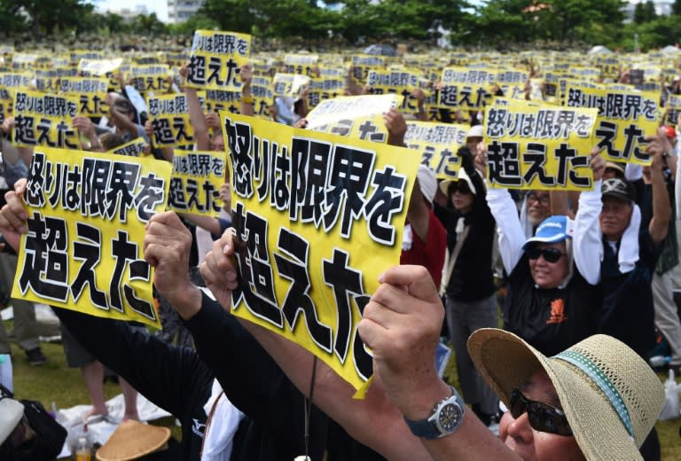 Demonstrators hold placards that read "our fury has gone beyond the limit" during a rally against the US military presence in Okinawa in 2016, following the alleged rape and murder of a local woman by a former US marine and a civilian worker