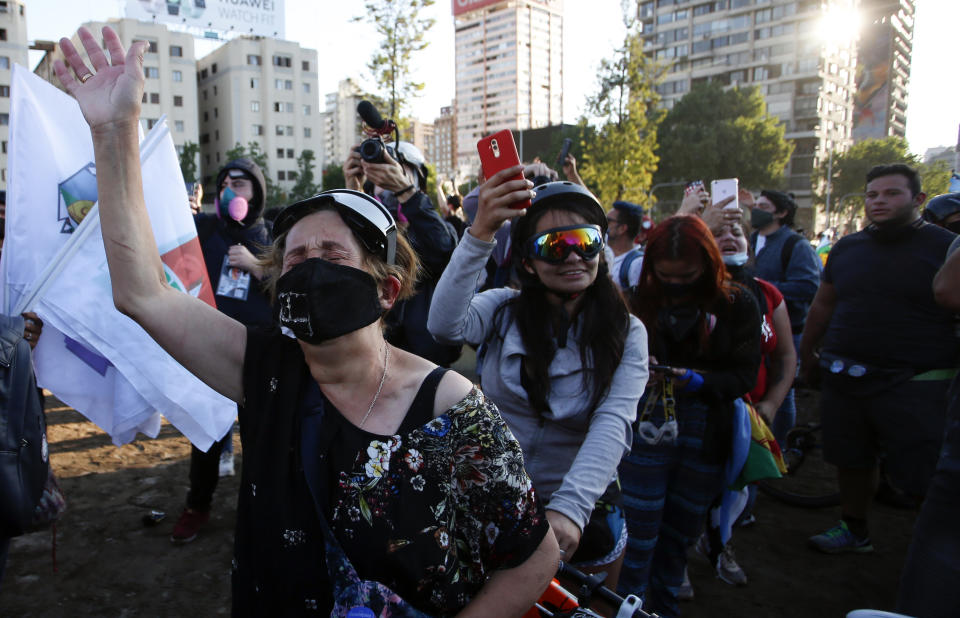 People gather at Plaza Italia on the day Chileans voted in a referendum to decide whether the country should replace its 40-year-old constitution, written during the dictatorship of Gen. Augusto Pinochet, in Santiago, Sunday, Oct. 25, 2020. (AP Photo/Luis Hidalgo)