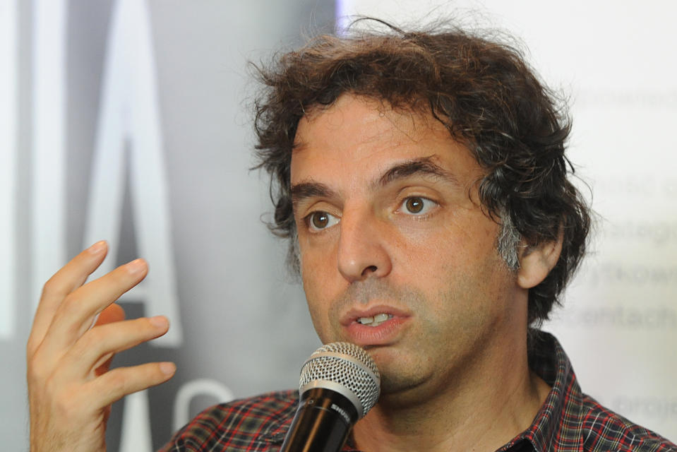 Israeli writer Etgar Keret speaks during a press conference one day ahead of the official opening of one of the world’s narrowest houses, in Warsaw, Poland, Friday, Oct. 19, 2012. The two-level “Keret’s House” is no wider than 122 centimeters (48.03 inches) and was fitted into tiny space puzzlingly left between a pre-war house and a modern apartment block of the 1960s in downtown Warsaw. It is named after Etgar Keret, an Israeli writer of Polish roots who will be the first inhabitant of this artistic project of aluminum and polycarbonate. (AP Photo/Alik Keplicz)