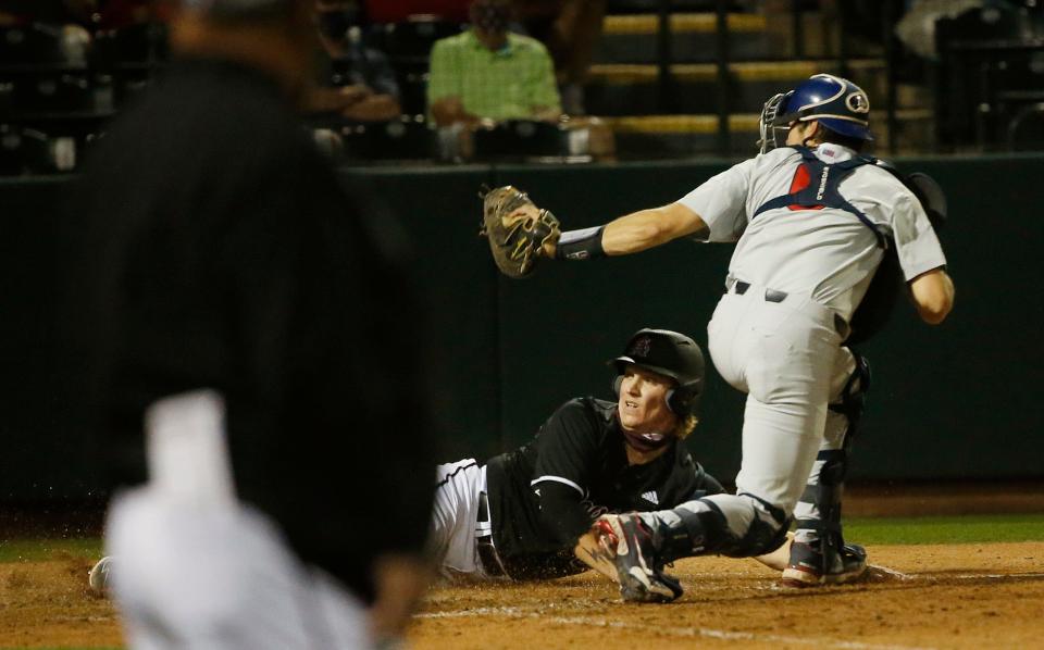 April 1, 2021; Phoenix, Arizona, USA; Arizona's Daniel Susac (6) tags out ASU's Ethan Long (35) at home plate during game one of a series at Phoenix Municipal Stadium. Mandatory Credit: Patrick Breen-Arizona Republic