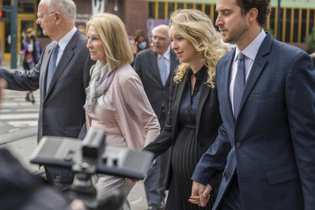 Theranos founder and CEO Elizabeth Holmes, second from right, walks into federal court in San Jose, Calif., Friday, Nov. 18, 2022. A federal judge will decide whether Holmes should serve a lengthy prison sentence for duping investors and endangering patients while peddling a bogus blood-testing technology. (AP Photo/Nic Coury)