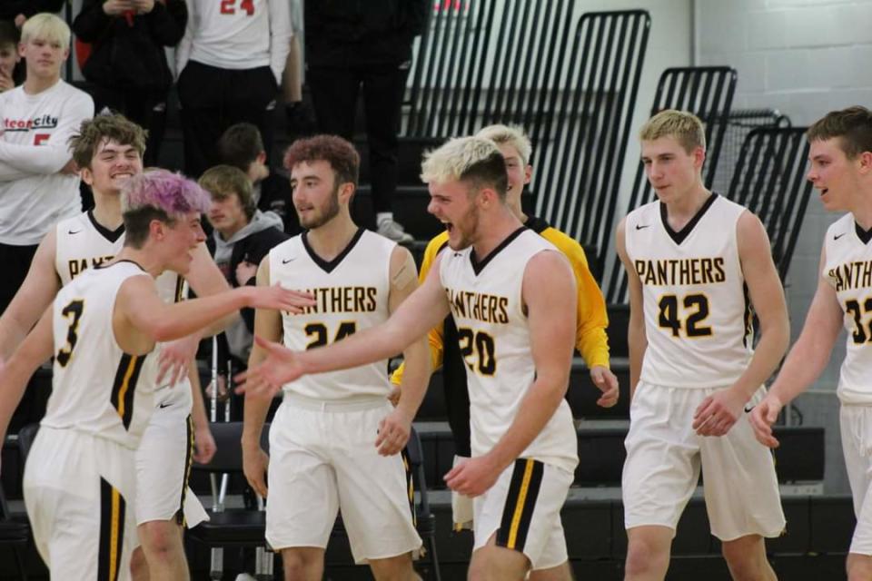 Gunar Lobdell, No. 20, celebrates his game-winning shot at the buzzer with his teammates at Lena-Winslow High School in Lena on Tuesday, Dec. 6, 2022.