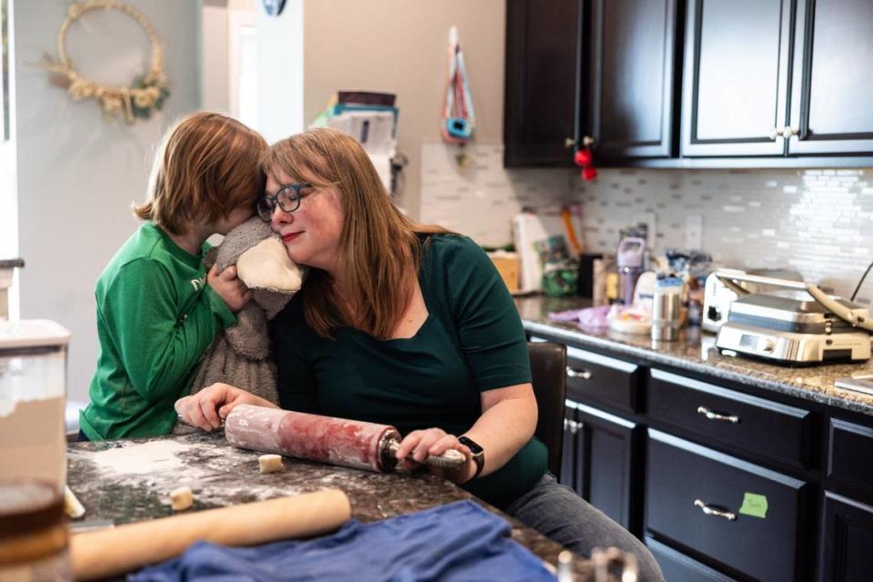 Mary Eggert makes dumplings as her son Griffin, 6, leans in for a hug at their home in Indian Land, SC, on Tuesday, March 26, 2024.