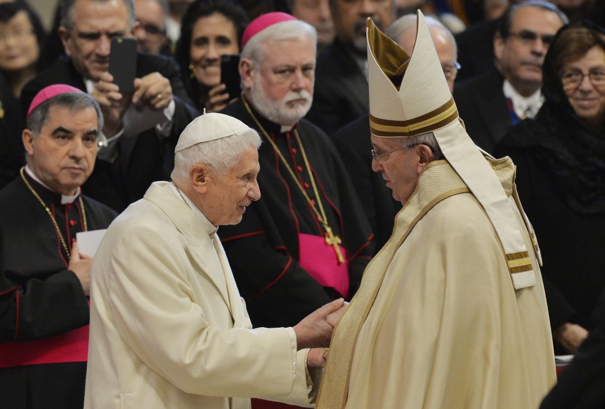 Pope Francis, right, greets Pope Emeritus Benedict XVI at&nbsp;St. Peter's Basilica on Feb. 14, 2015. (Photo: ANDREAS SOLARO via Getty Images)