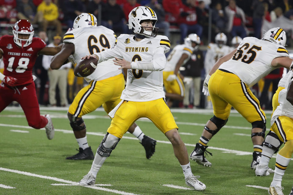 Wyoming quarterback Andrew Peasley drops back to pass against Fresno State during the first half of an NCAA college football game in Fresno, Calif., Friday, Nov. 25, 2022. (AP Photo/Gary Kazanjian)