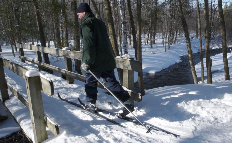 FILE - This March 9, 2008 file photo shows a cross-country skier along the Bruce Trail on the Niagara Escarpment in Milton, west of Toronto. The Bruce Trail is the oldest and longest marked hiking trail in Canada at 521 miles (840 kilometers) long and over 273 miles (440 kilometers) of side trails, many of which are in Ontario. While autumn turns the trails into blazing streams of fiery reds, pumpkin orange and honeyed hues, the winter snow makes it perfect for cross-country skiing and snow-shoeing. (AP Photo/The Canadian Press, J.P. Moczulski, file)