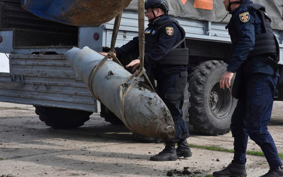 Emergency workers remove a FAB-500 unexploded Russian air bomb in the town of Preobrazhenka - Andriy Andriyenko/AP