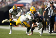 Green Bay Packers linebacker Kingsley Enagbare (55) tackles Chicago Bears wide receiver DJ Moore as safety Rudy Ford (20) also pursues during the first half of an NFL football game Sunday, Sept. 10, 2023, in Chicago. (AP Photo/Erin Hooley)