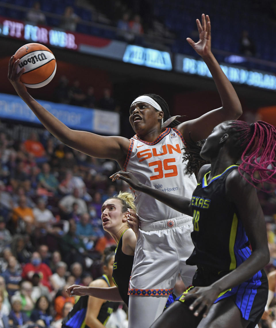 Connecticut Sun forward Jonquel Jones (35) beats Dallas Wings center Awak Kuier (28) to a rebound during Game 1 of a WNBA basketball first-round playoff series Thursday, Aug. 18, 2022, in Uncasville, Conn. (Sean D. Elliot/The Day via AP)