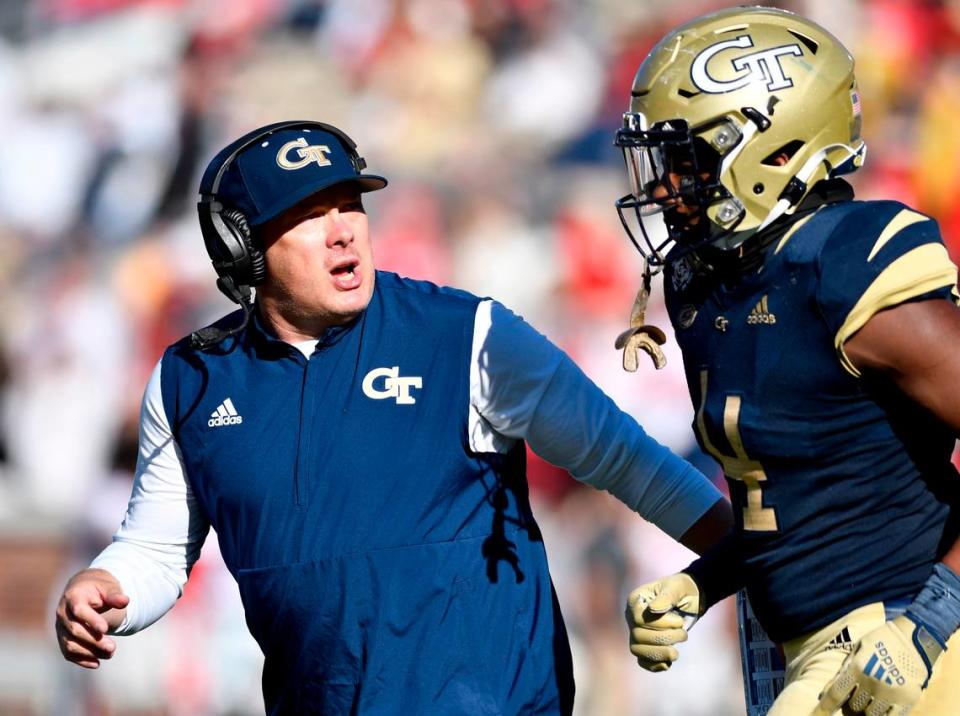 Georgia Tech head coach Geoff Collins speaks with linebacker Quez Jackson (4) during the Yellow Jackets 45-0 loss to Georgia Saturday in Atlanta.