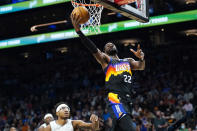 Phoenix Suns center Deandre Ayton (22) gets past Orlando Magic center Wendell Carter Jr. to score during the first half of an NBA basketball game Saturday, Feb. 12, 2022, in Phoenix. (AP Photo/Ross D. Franklin)