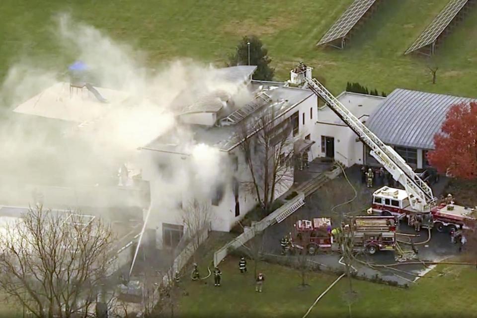 Dramatic images showed smoke billowing into the sky from the luxury home (AP)