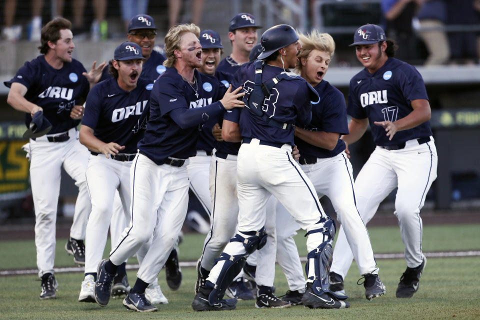 Oral Roberts players celebrate their 11-6 win over Oregon in an NCAA college baseball tournament super regional game, Sunday, June 11, 2023, in Eugene, Ore. (AP Photo/Amanda Loman)