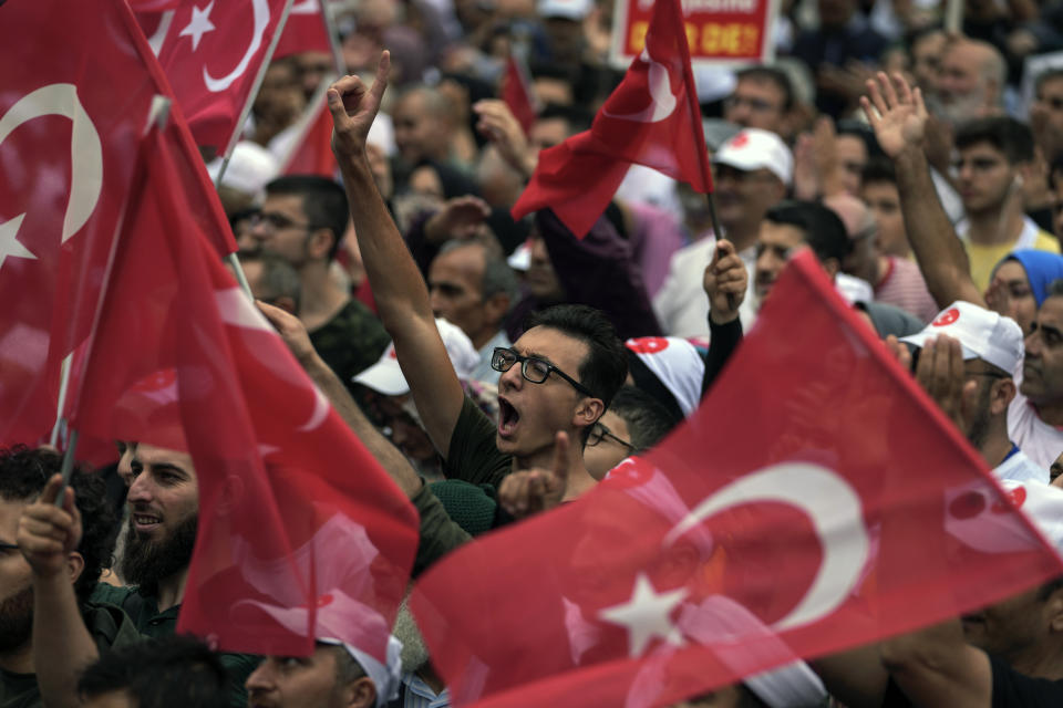 FILE - Demonstrators chant slogans while holding Turkish flags during an anti LGBTQ protest, in Fatih district of Istanbul, Sunday, Sept. 18, 2022. (AP Photo/Khalil Hamra, File)