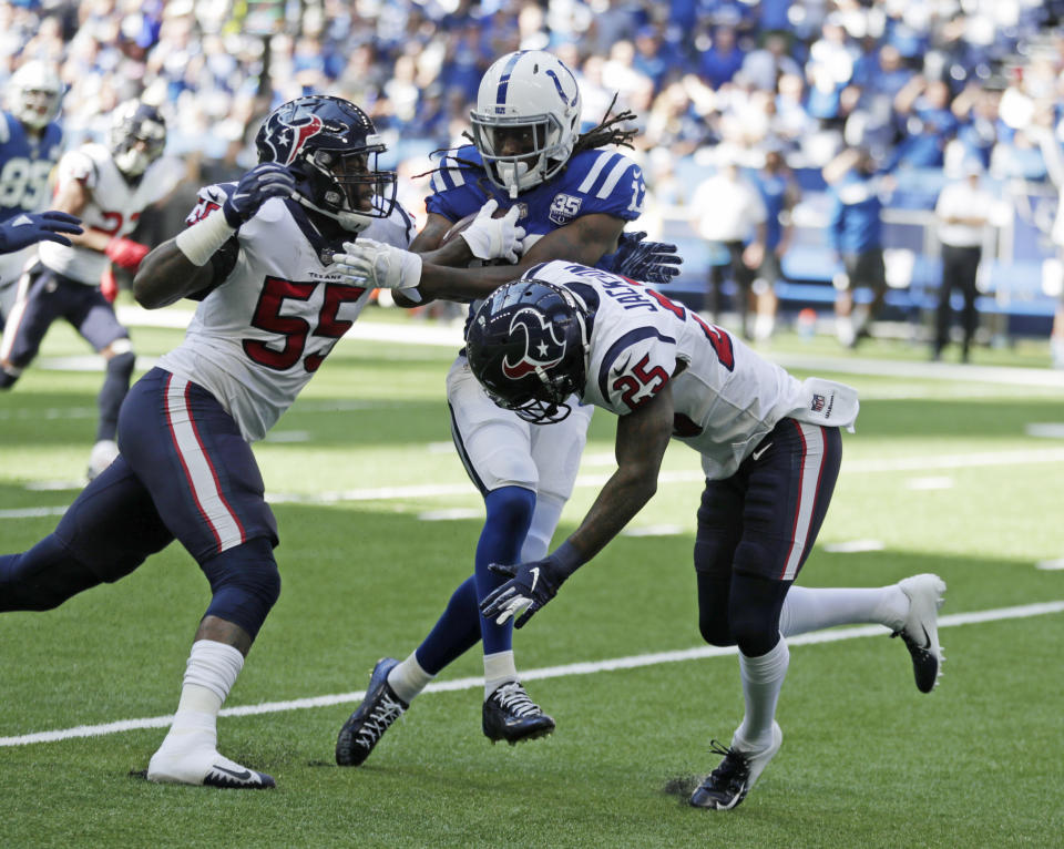 Indianapolis Colts' T.Y. Hilton (13) is tackled by Houston Texans' Kareem Jackson (25) and Benardrick McKinney (55) during the first half of an NFL football game, Sunday, Sept. 30, 2018, in Indianapolis. (AP Photo/Michael Conroy)