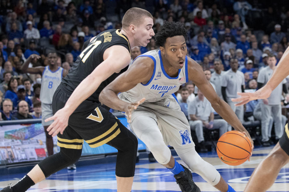 Memphis forward Nae'Qwan Tomlin (7) drives against the defense of Vanderbilt forward Tason Kamateros (21) during the first half of an NCAA college basketball game Saturday, Dec. 23, 2023, in Memphis, Tenn. (AP Photo/Nikki Boertman)