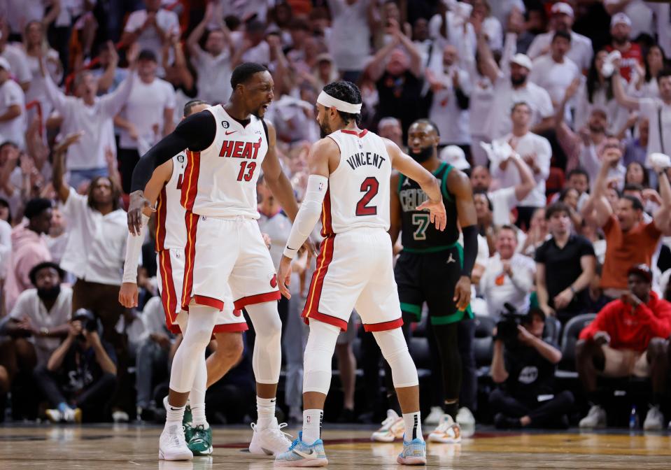 Game 3: Heat center Bam Adebayo (13) and guard Gabe Vincent (2) celebrate as fans go wild during Miami's 128-102 rout of the Boston Celtics to take a 3-0 lead in the Eastern Conference finals.