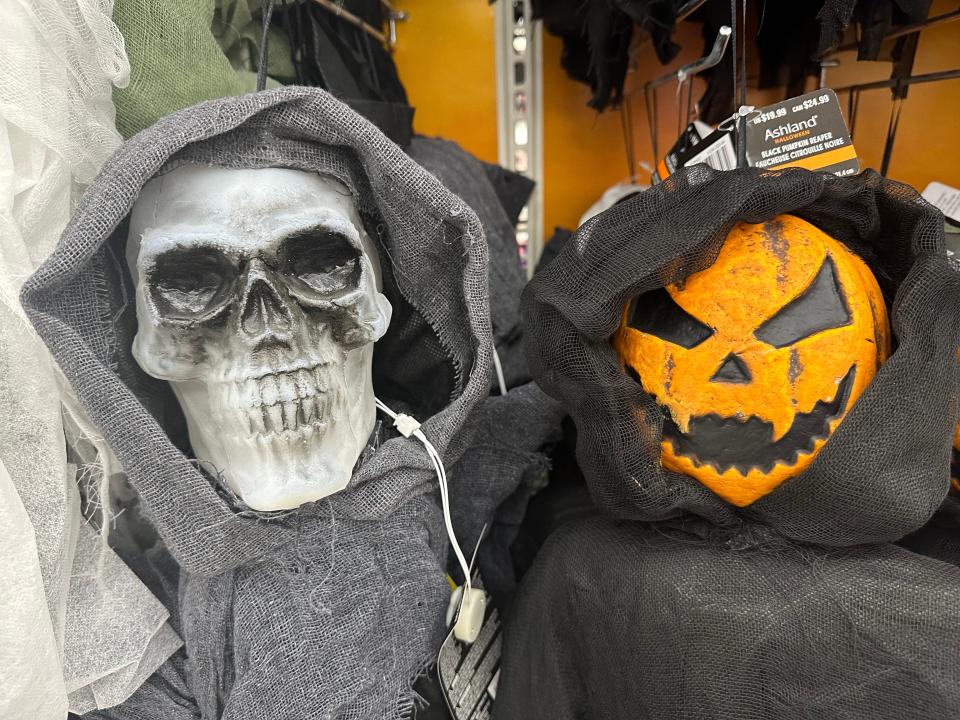 A skeleton and pumpkin in hoods as decorations