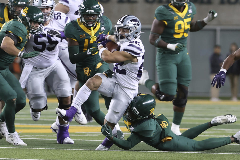 Kansas State running back Deuce Vaughn (22) breaks free from Baylor cornerback Mark Milton in the first half of an NCAA college football game, Saturday, Nov. 12, 2022, in Waco, Texas. (AP Photo/Jerry Larson)