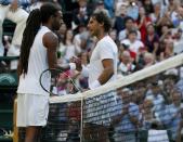 Dustin Brown of Germany shakes hands with Rafael Nadal of Spain after winning their match at the Wimbledon Tennis Championships in London, July 2, 2015. REUTERS/Stefan Wermuth