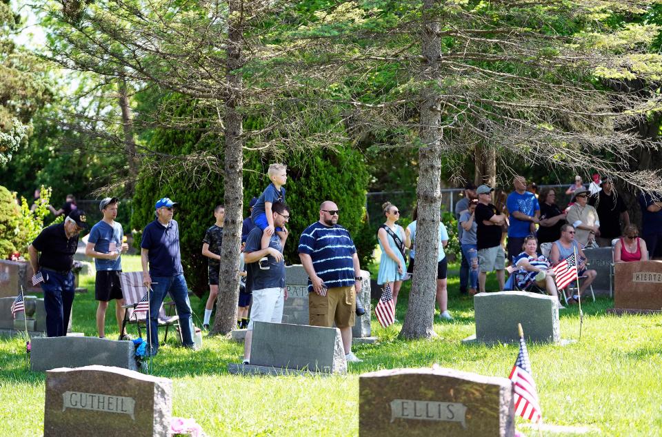 Grove City residents watch a ceremony at the Grove City Cemetery during the city's Memorial Day parade Monday, the first since the COVID-19 pandemic struck two years ago.