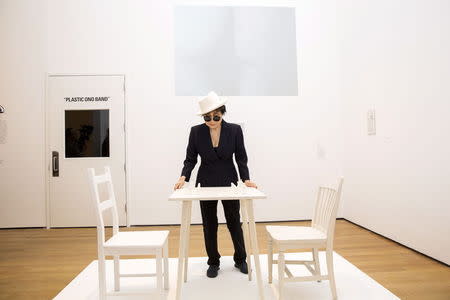 Artist Yoko Ono interacts with the exhibit "White Chess Set" at the Museum of Modern Art exhibition dedicated exclusively to her work, titled "Yoko Ono: One Woman Show, 1960-1971", in New York May 12, 2015. REUTERS/Lucas Jackson