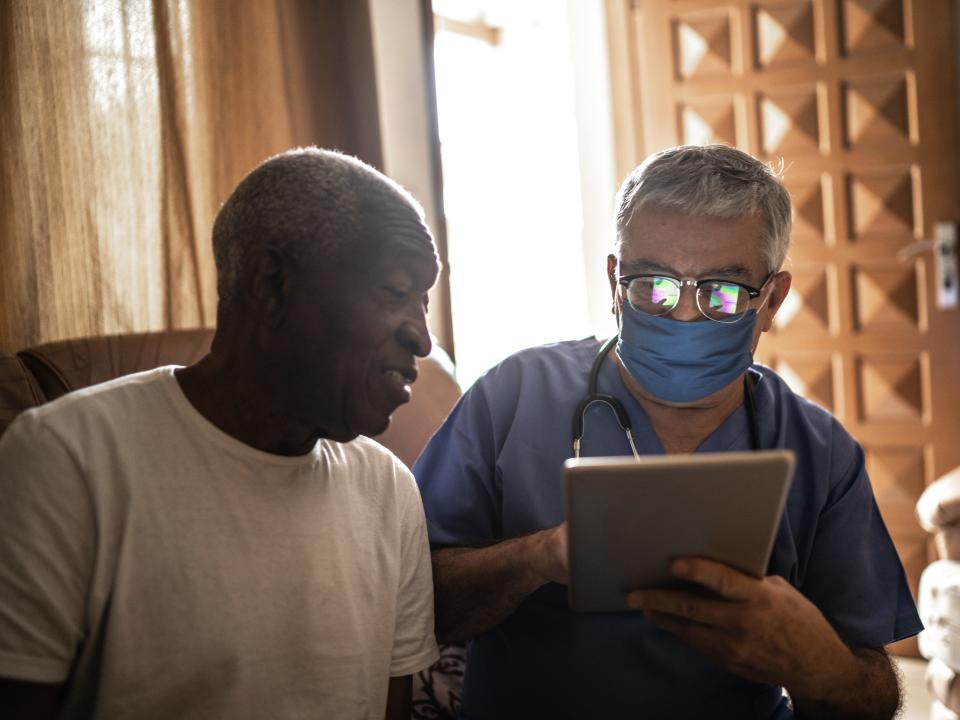 A stock photo of a black patient with a doctor.
