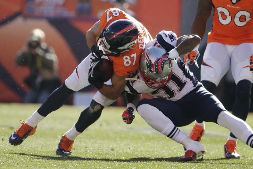 Denver Broncos wide receiver Eric Decker (87) is stopped New England Patriots cornerback Aqib Talib (31) during the first half of the AFC Championship NFL playoff football game in Denver, Sunday, Jan. 19, 2014. (AP Photo/Charlie Riedel)