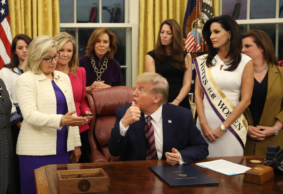 Then-President Donald Trump talks with Rep. Liz Cheney (left) after a bill-signing in the Oval Office at the White House in 2019. (Photo: Mark Wilson via Getty Images)