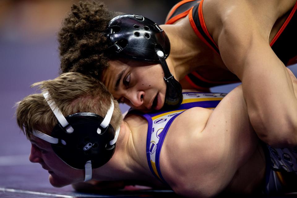 Jabari Hinson of Ames wrestles against Ryan Young of Indianola during the first day of the IHSAA 3A State Championships on February 15th at Wells Fargo Arena.