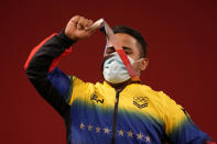 Keydomar Giovan Vallenilla Sanchez of Venezuela celebrates after winning the silver medal in the men's 96kg weightlifting event, at the 2020 Summer Olympics, Saturday, July 31, 2021, in Tokyo, Japan. (AP Photo/Luca Bruno)