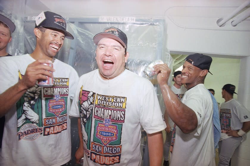 San Diego Padres' pitcher Fernando Valenzuela, center, is doused with beer by the teammate Rickey Henderson.