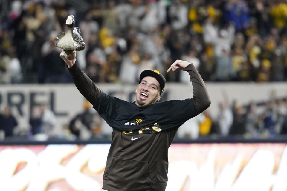 San Diego Padres pitcher Blake Snell runs with a goose decoy after the Padres defeated the Los Angeles Dodgers 5-3 in Game 4 of a baseball NL Division Series, Saturday, Oct. 15, 2022, in San Diego. (AP Photo/Jae C. Hong)