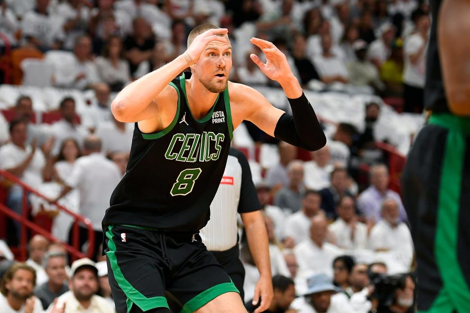 Apr 29, 2024; Miami, Florida, USA; Boston Celtics center Kristaps Porzingis (8) reacts to a foul call while playing the Miami Heat during the first quarter of game four of the first round for the 2024 NBA playoffs at Kaseya Center. Mandatory Credit: Michael Laughlin-USA TODAY Sports