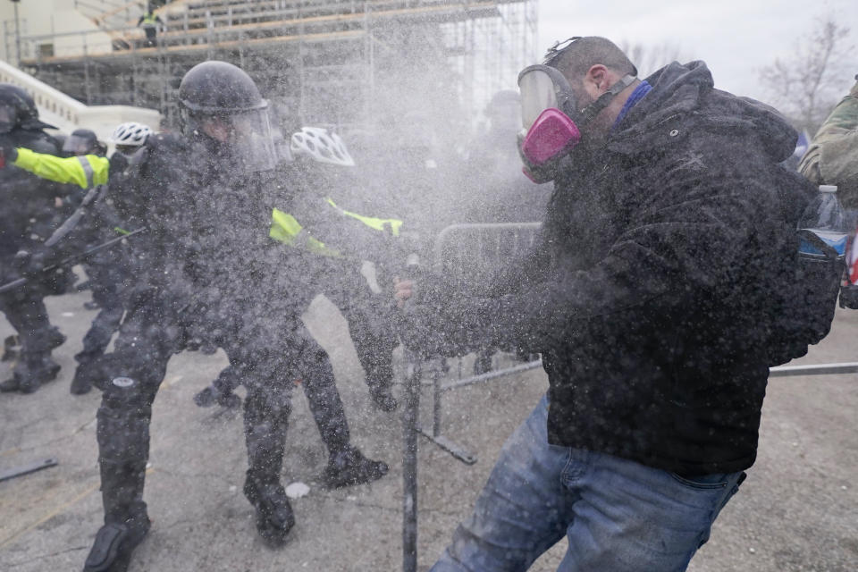 FILE - Rioters loyal to President Donald Trump at the U.S. Capitol on Jan. 6, 2021, in Washington. Liberal groups are trying to end Trump's attempt to return to the White House by arguing that he is no longer eligible to be president after trying to overturn the 2020 election results.(AP Photo/Julio Cortez, File)