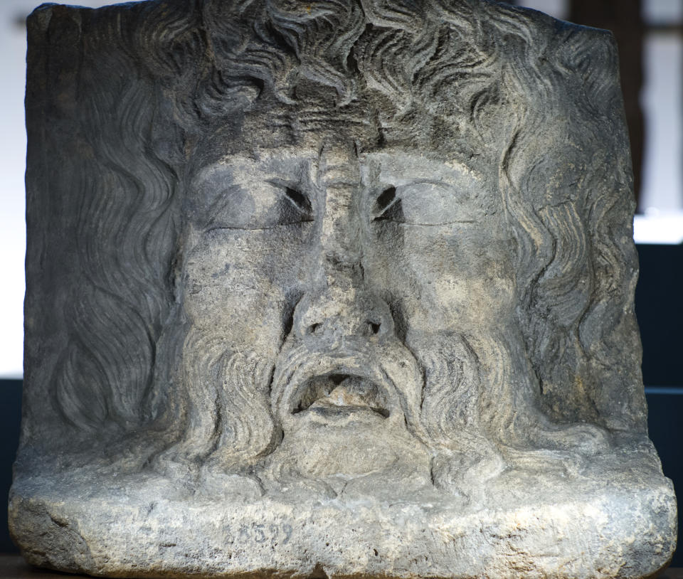 In this Sept. 20, 2018 photo a River God Mask from Roman-era in Cologne is displayed at an archeological exhibition at the Martin-Gropius-Bau museum in Berlin. The new exhibition showcasing more than 1,000 major archaeological finds from the past 20 years shows reveals how Germany has been at the heart of European trade, migration, conflict and innovation since the Stone Age. The exhibition runs from Sept. 21, 2018 until Jan. 6, 2019. (AP Photo/Markus Schreiber)