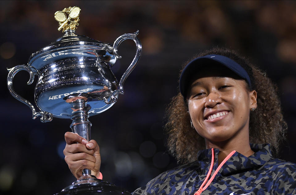 Japan's Naomi Osaka holds the Daphne Akhurst Memorial Cup after defeating United States Jennifer Brady in the women's singles final at the Australian Open tennis championship in Melbourne, Australia, Saturday, Feb. 20, 2021.(AP Photo/Andy Brownbill)