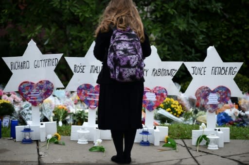 A woman stands at a memorial outside the Tree of Life synagogue in Pittsburgh, Pennsylvania after a shooting there left 11 people dead on October 27, 2018