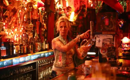 Lea, owner of the club "Wild at Heart", stands at a bar in Berlin, Germany, September 1, 2016. Lea and her husband Uli, who sings in the band "Church of Confidence", have been running "Wild at Heart" for over 20 years. REUTERS/Hannibal Hanschke