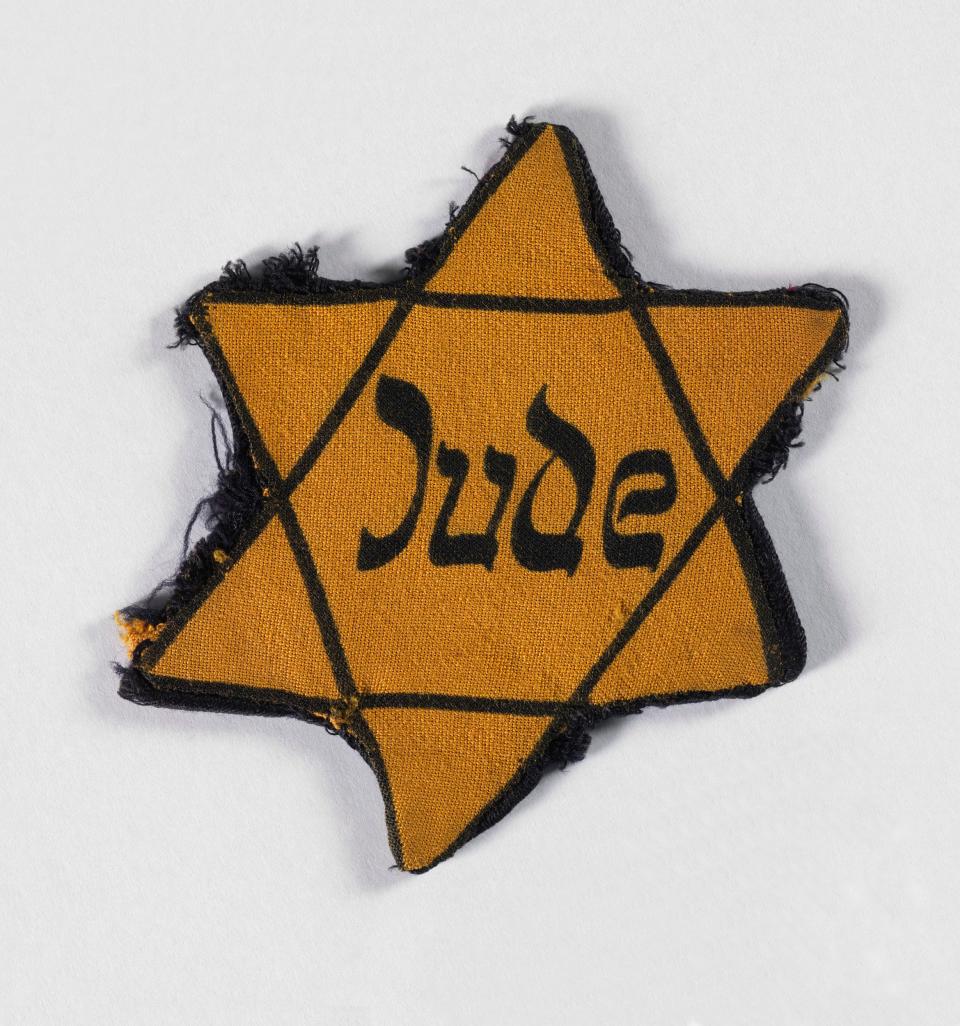 This yellow fabric star belonged to Emmanuel Seinfeld, who survived the war and whose daughter came to Britain on the Kindertransport - IWM