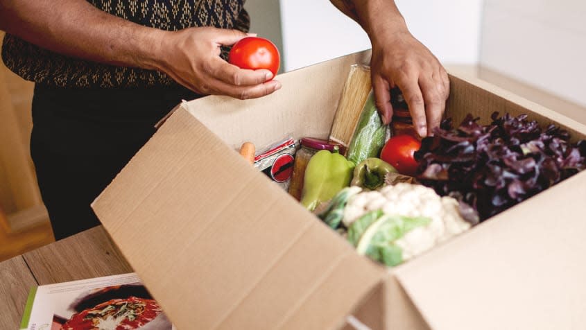 Open cardboard box with vegetables