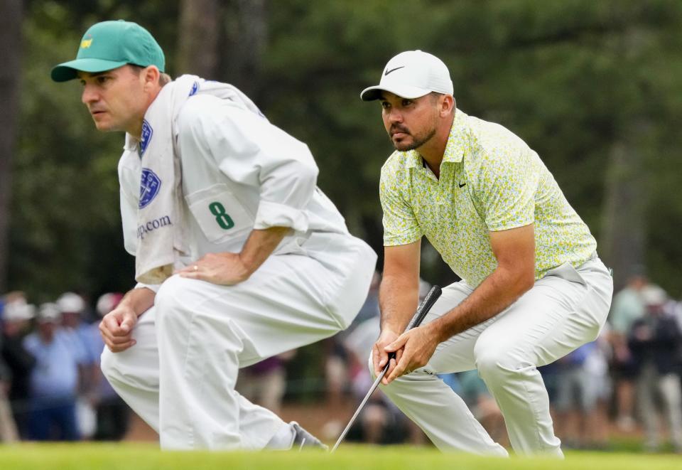 Apr 7, 2023; Augusta, Georgia, USA; Jason Day, and William Kane, caddie for Gordon Sargent, check the lie of the first green during the second round of The Masters golf tournament. Mandatory Credit: Rob Schumacher-USA TODAY Network