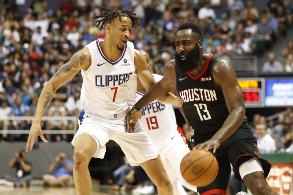 Los Angeles Clippers shooting guard Amir Coffey (7) guards Houston Rockets shooting guard James Harden (13) during the second quarter of an NBA preseason basketball game, Thursday, Oct 3, 2019, in Honolulu. (AP Photo/Marco Garcia)