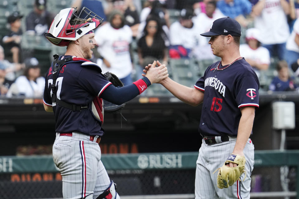Minnesota Twins catcher Ryan Jeffers, left, celebrates with relief pitcher Emilio Pagan, right, after they defeated the Chicago White Sox in a baseball game in Chicago, Sunday, Sept. 17, 2023. (AP Photo/Nam Y. Huh)