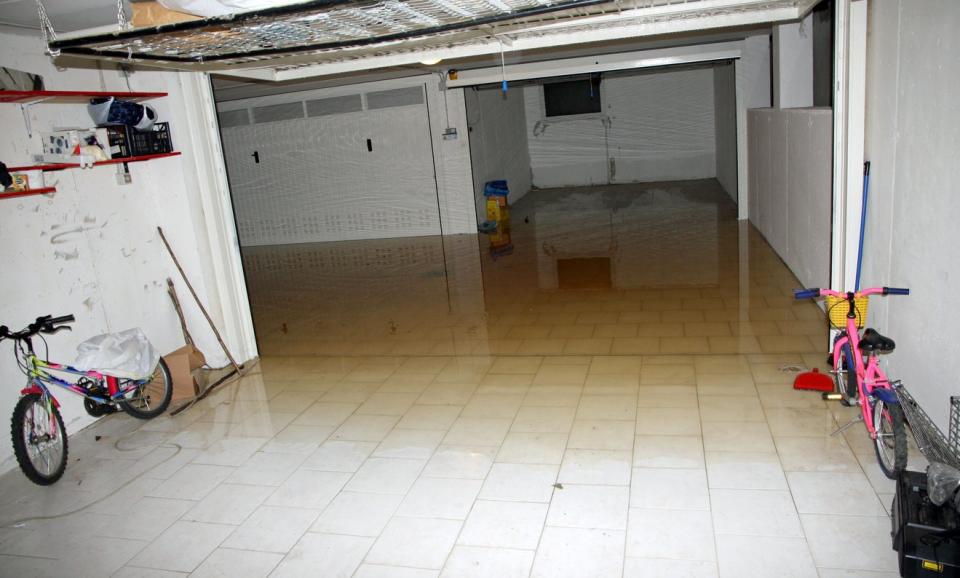 Basement garage flooded with water and belongings wet or ruined