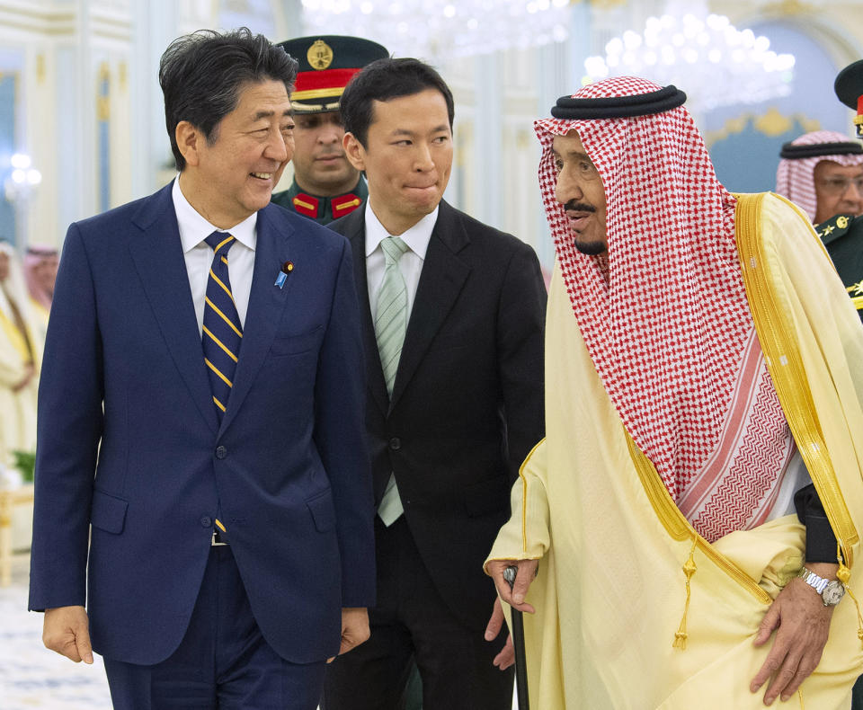 In this photo released by the Saudi Royal Palace, Saudi King Salman, right, receives Japan's Prime Minister Shinzo Abe, in Riyadh, Saudi Arabia, Sunday, Jan. 12, 2020. (Bandar Aljaloud/Saudi Royal Palace via AP)