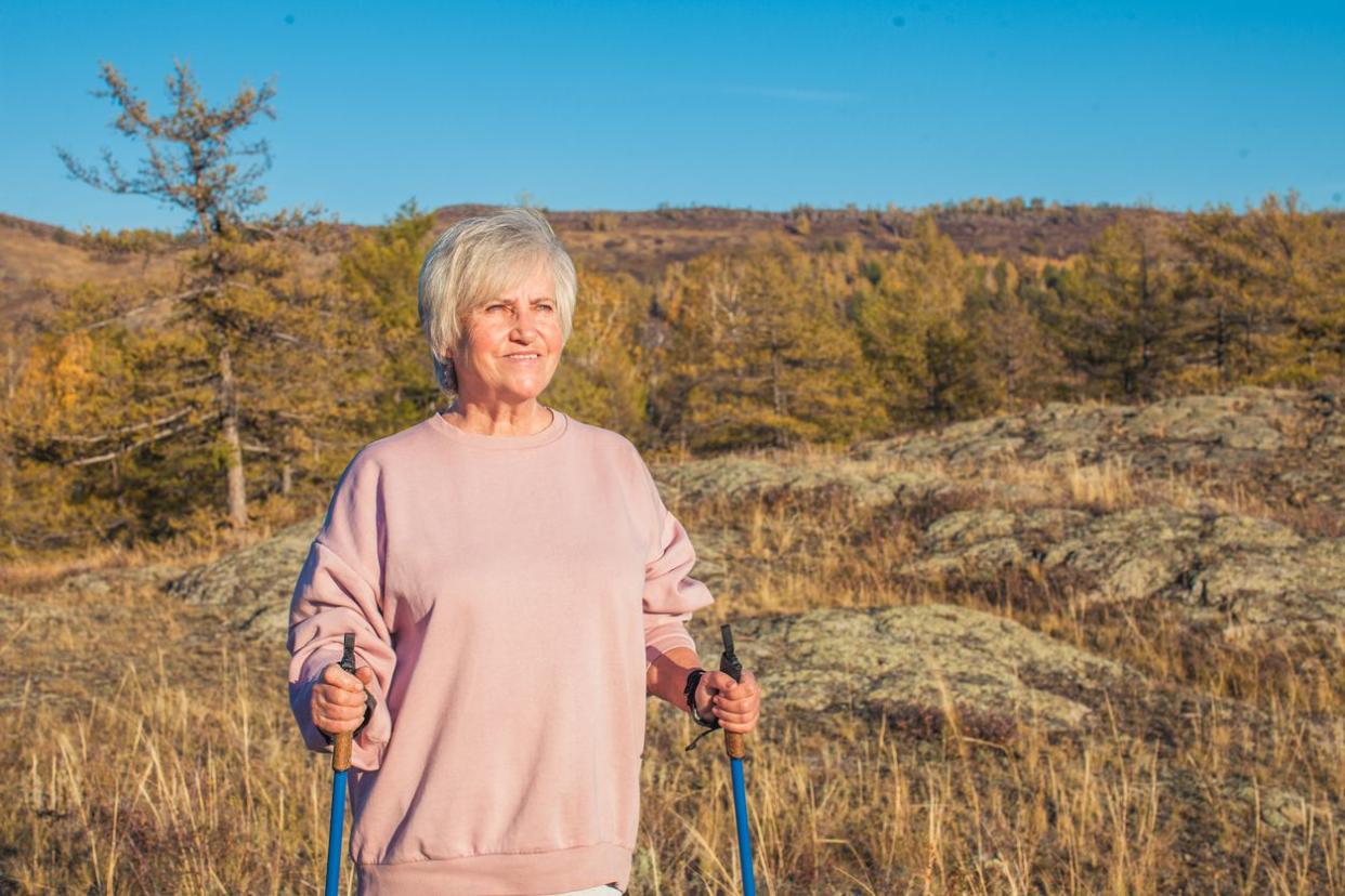 Elderly woman using rehab poles